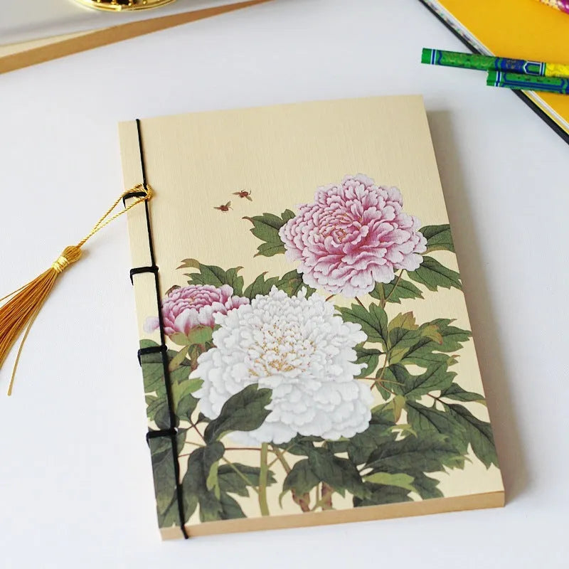 A5 antique art notebook with wire binding, decorative tassels, and traditional Chinese painting cover design