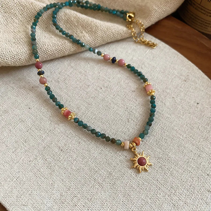 Freshwater pearl necklace with stone sun pendant on adjustable clavicle chain in blue and golden pink colours
