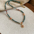 Freshwater pearl necklace with stone sun pendant on adjustable clavicle chain in blue and golden pink colours