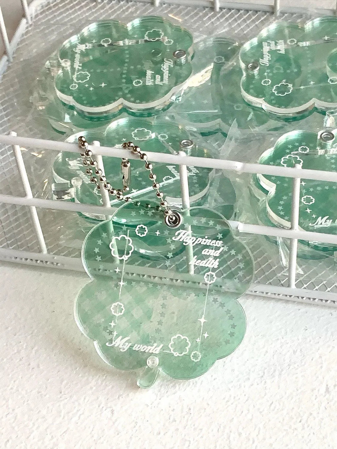 Acrylic four-leaf clover phone pendant keychain in blue, green, or mint green.