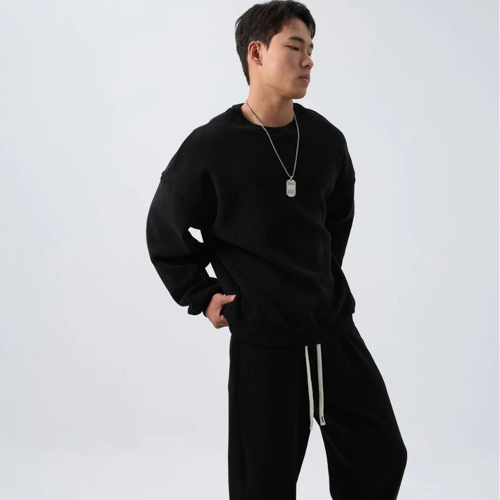 Men's black polar fleece tracksuit with crew neck jacket and matching padded trousers