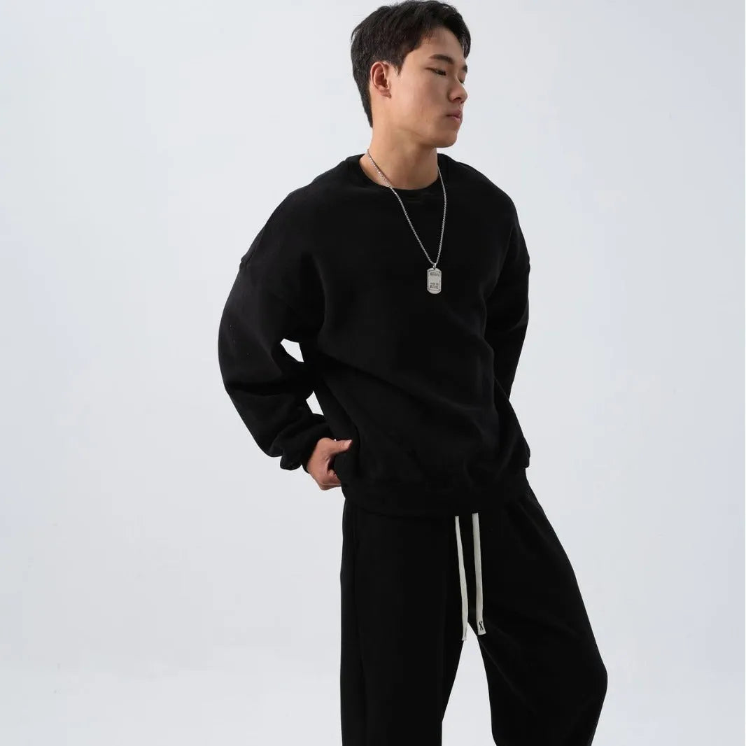 Men's black polar fleece tracksuit with crew neck jacket and matching padded trousers