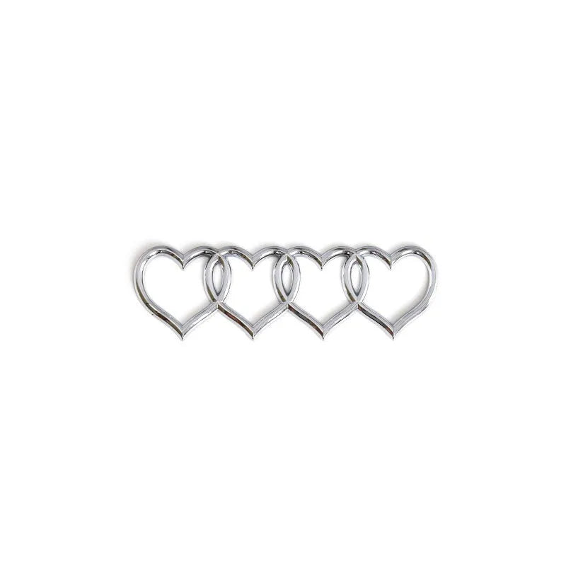 Heart-shaped body sticker with four-ring tail design in electroplated silver colour on a car bumper