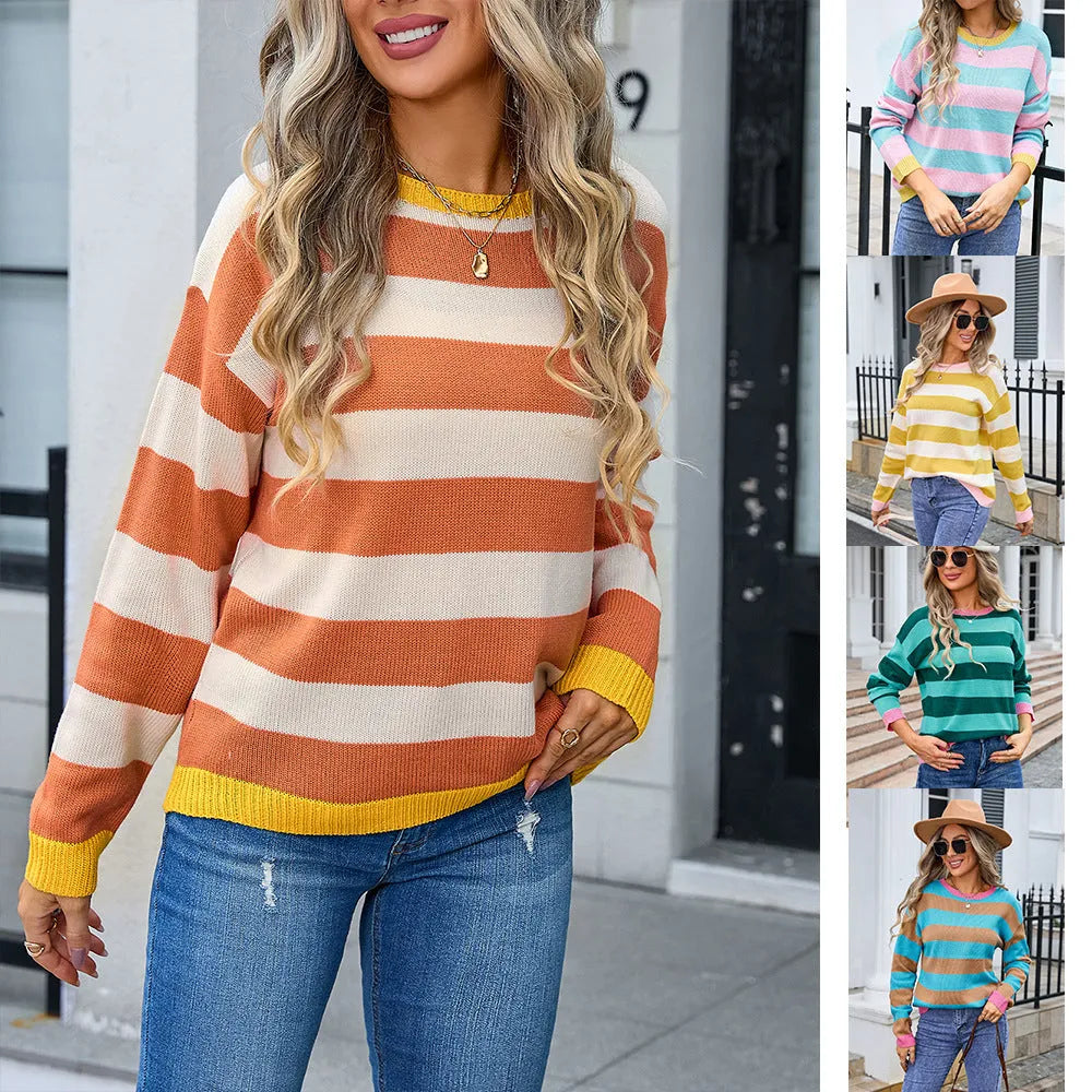 Women's loose fit acrylic sweater in blue with stripes, showing round neck and long sleeves.