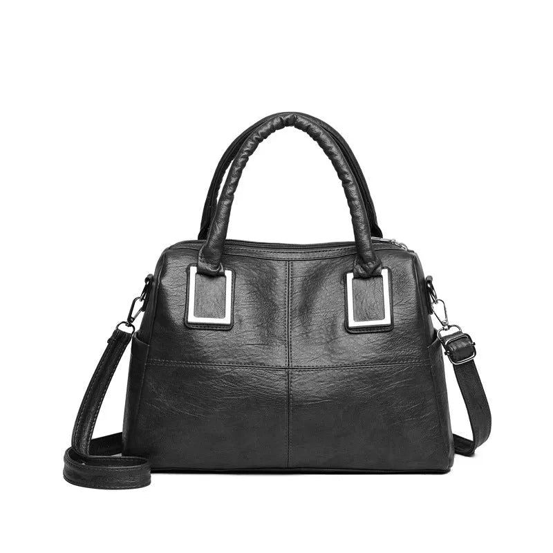 Simple large capacity women's shoulder bag in a square shape, shown in a neutral colour with visible structure.