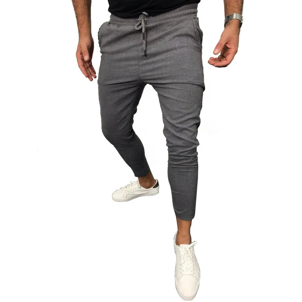 Lace-up casual jogging pants in solid light grey, nine points length, mid-waist, with adjustable front laces