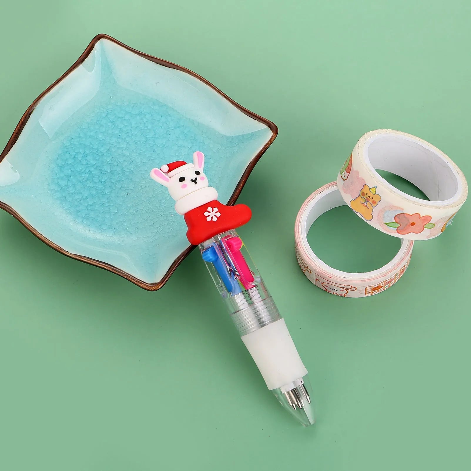 Christmas mini four-colour press-type ballpoint pen showing festive designs, 11cm long.