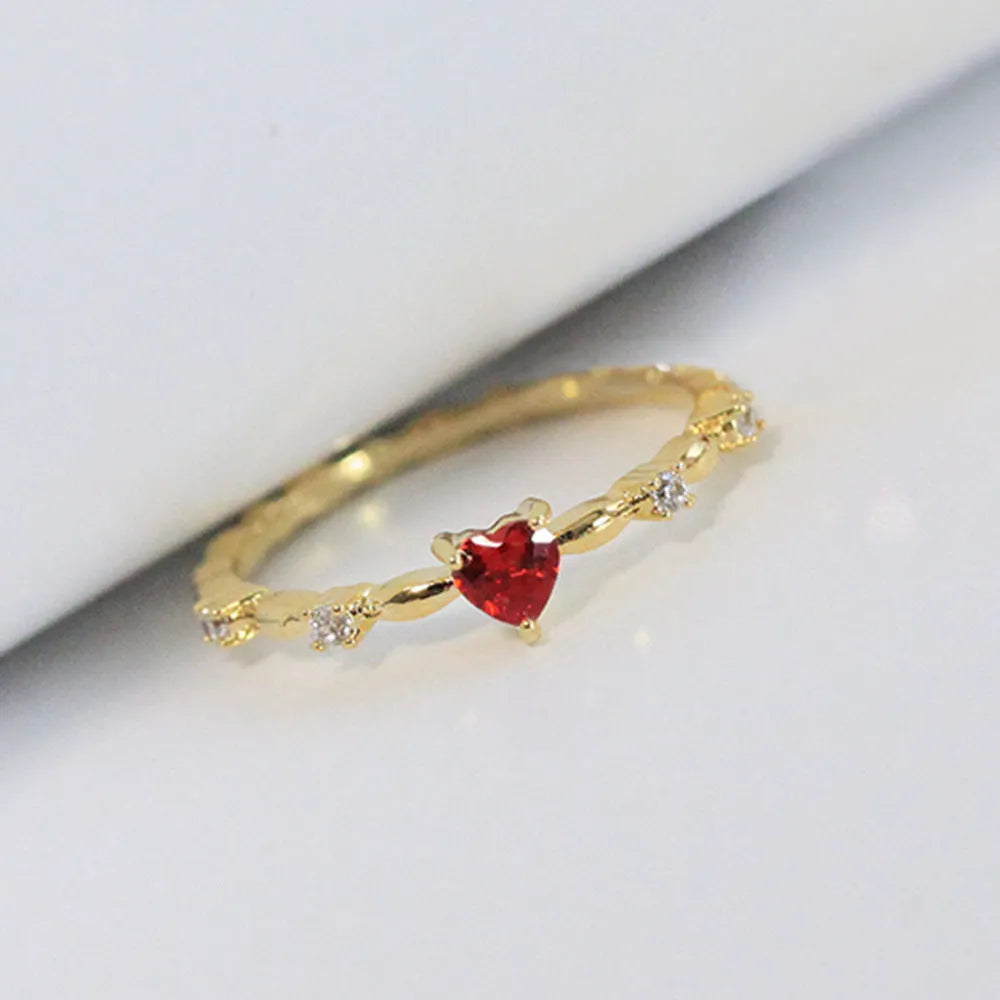 Gold or silver colour peach heart shaped ring with zircon stones on a copper band.