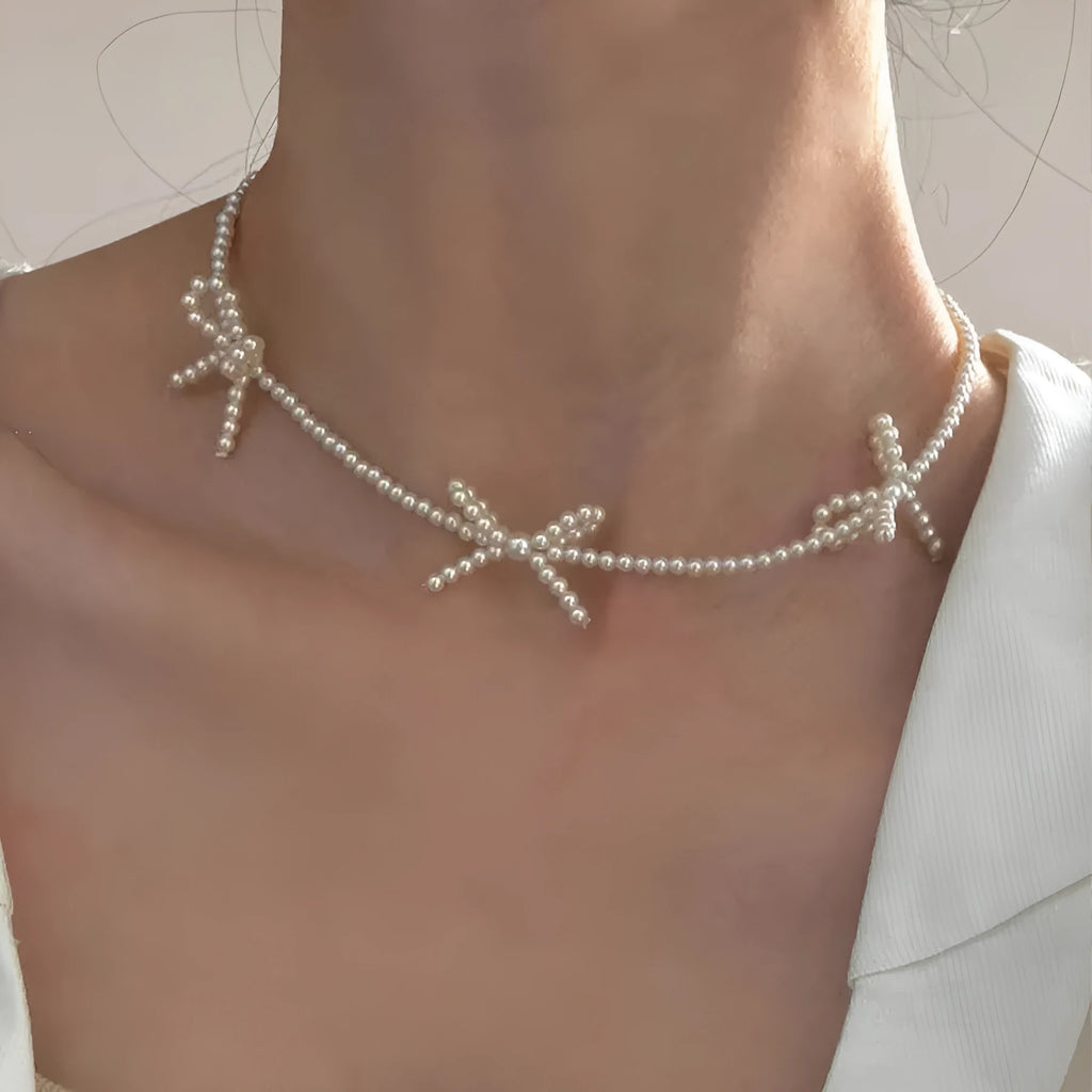 White imitation pearl necklace with geometric bow pendant on adjustable 31-40cm chain