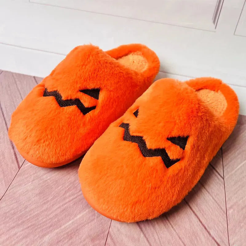 Orange Halloween pumpkin slippers with coral velvet upper and plush lining.