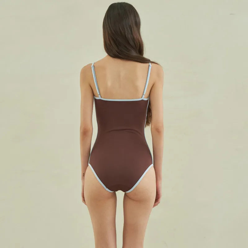 Brown triangle-style one-piece swimsuit for women on a mannequin.