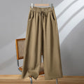 Women's straight leg casual trousers in khaki with an elastic waistband and lace-up drawstring detail.