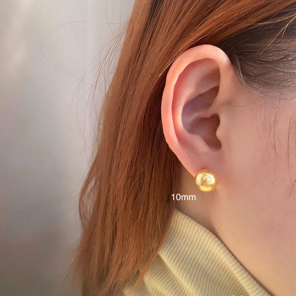 Large geometric pearl stud earrings for women with an eight-point star detail, shown in silver.