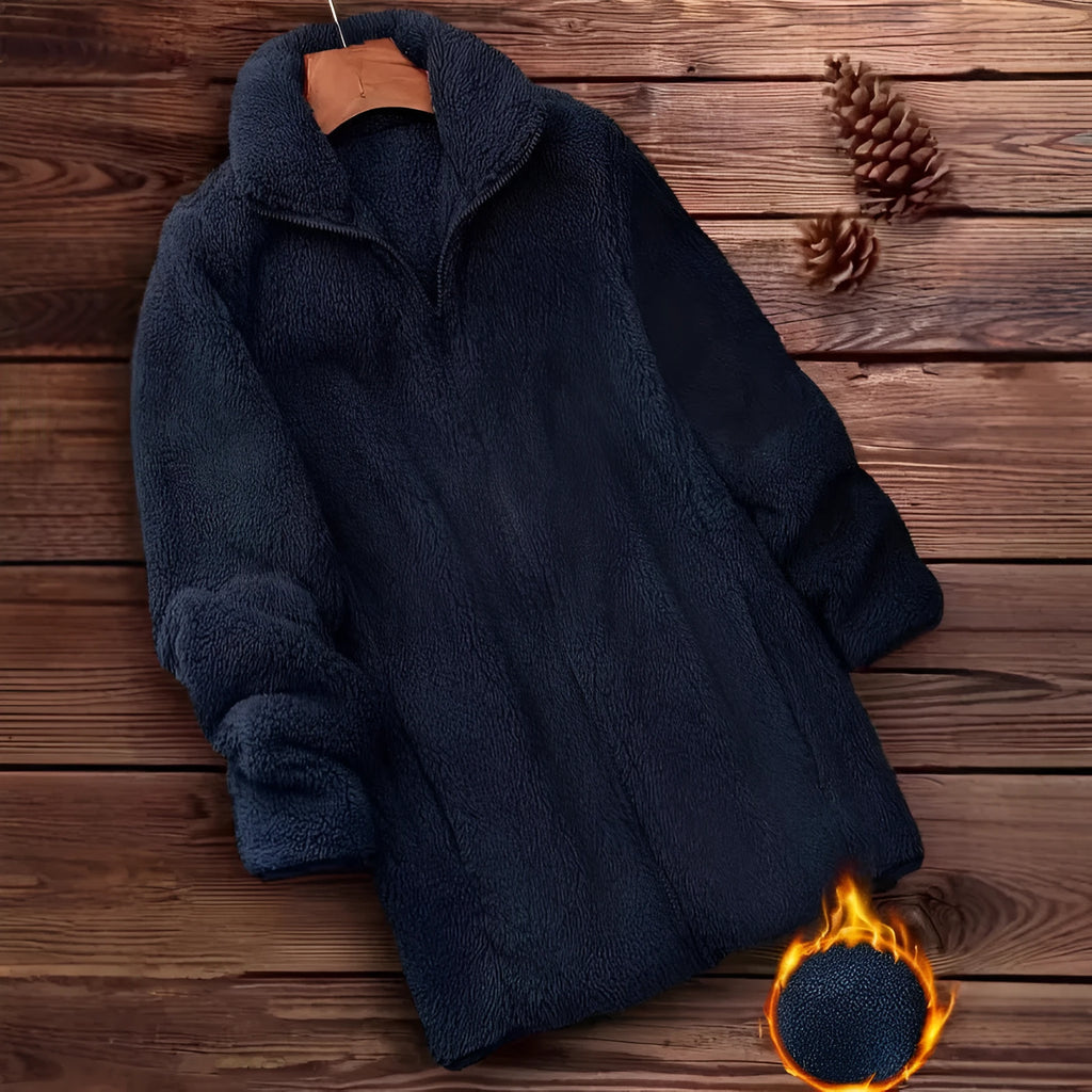 Man wearing a double-sided black fleece jacket with a velvet texture.