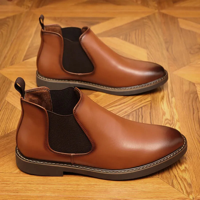 Black formal pointed-toe leather boots with a square heel and rubber sole on a neutral background.