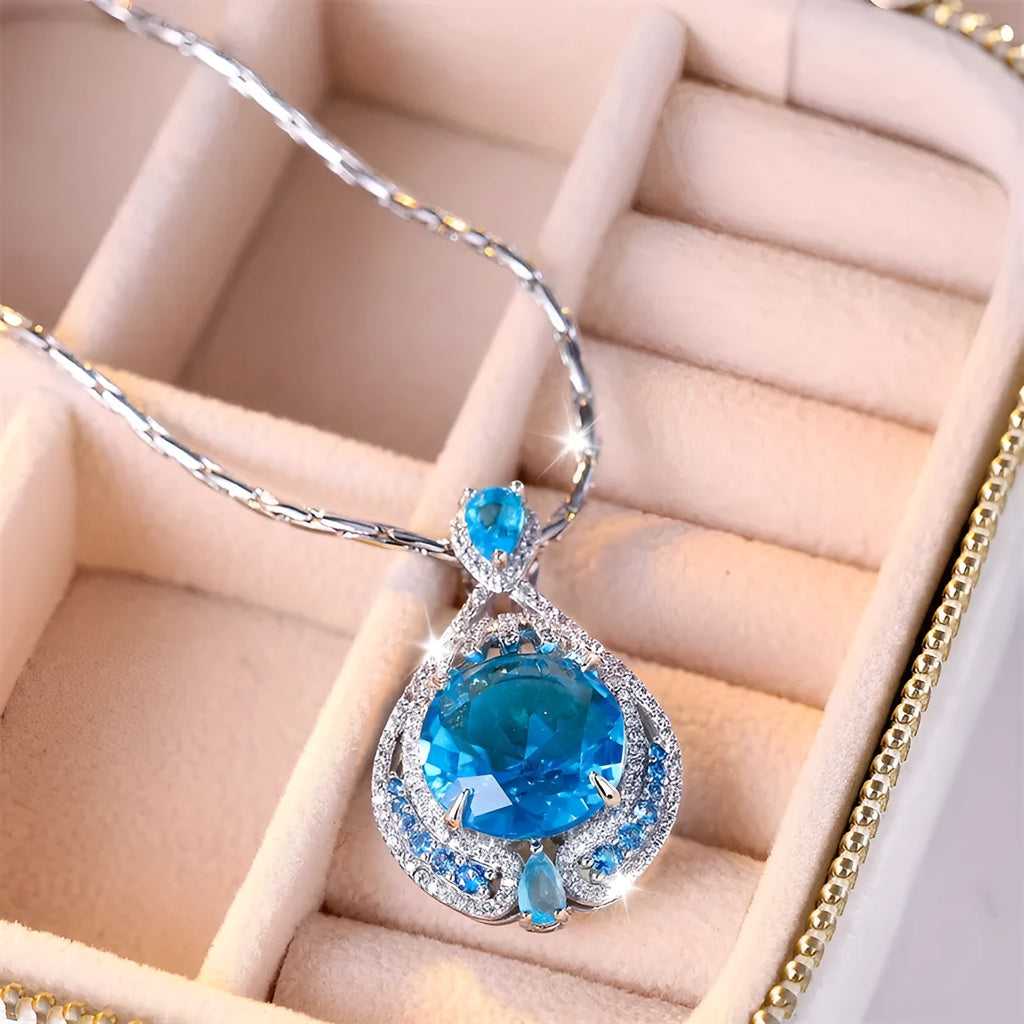 Geometric women's necklace with blue crystal pendant on water wave chain