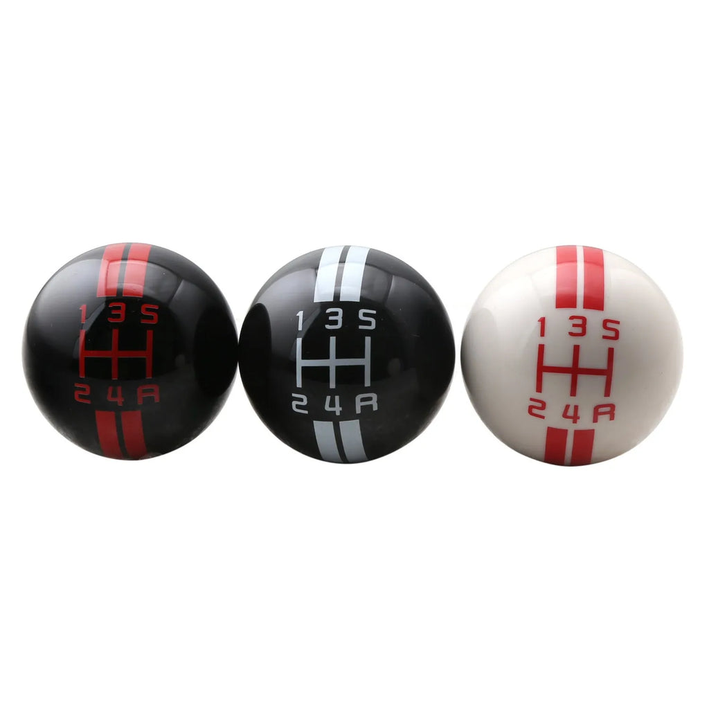 Black acrylic car gear shift knob showing 5-speed pattern with white lettering, next to three screw accessories.