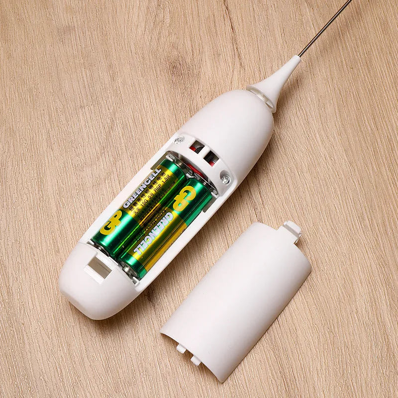 Black and white handheld electric milk frother with blending function on kitchen counter