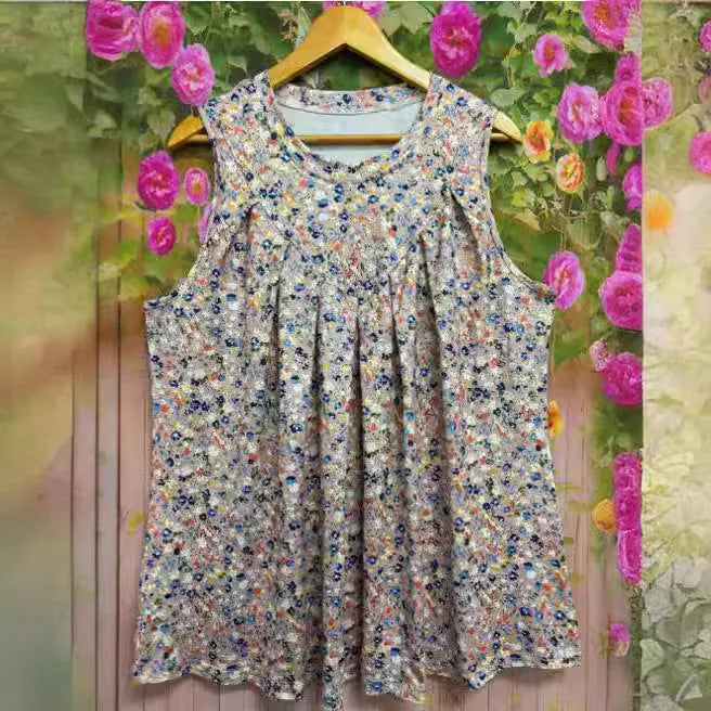 Black plus-size floral print sleeveless vest on a hanger, showing round neck and loose fit.