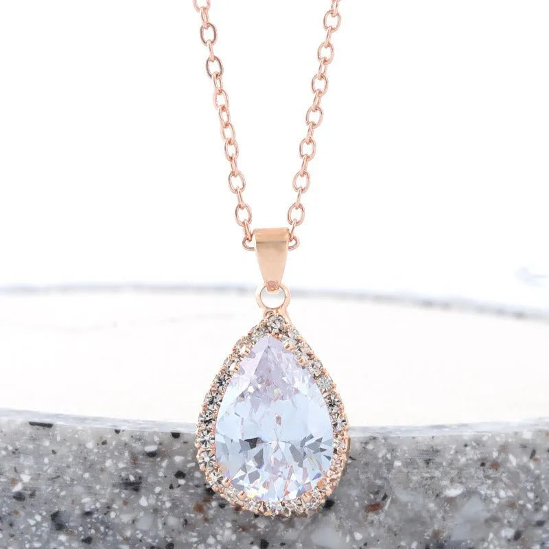 Women's pink rhinestone drop necklace with rose gold electroplated finish and geometric design