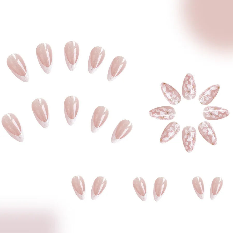 Short almond-shaped false nails with French style tips and glittering pink powder flowers on a white background.