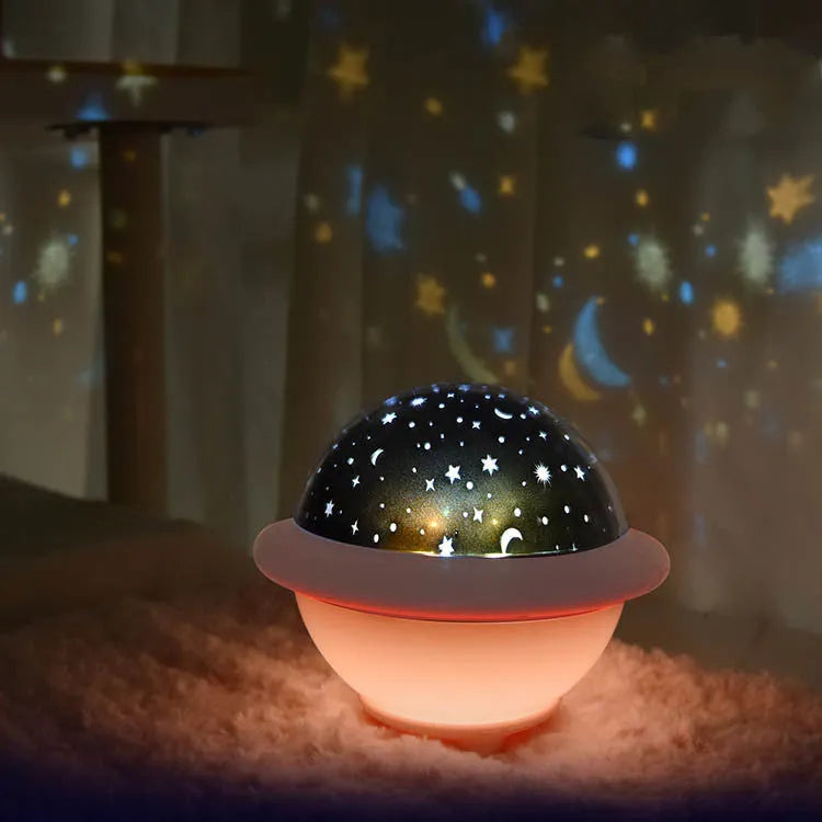 Green UFO-shaped starry sky projection night light with LED lighting on table