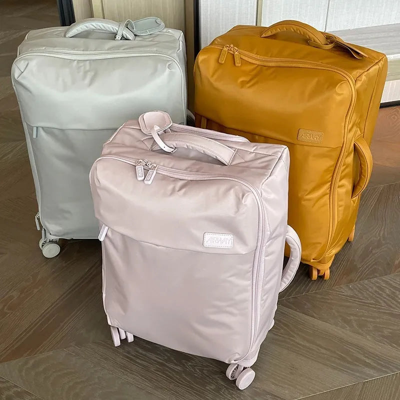 Ultra-light waterproof Oxford cloth suitcase in bluestone green with universal wheels, shown in a 24-inch size.