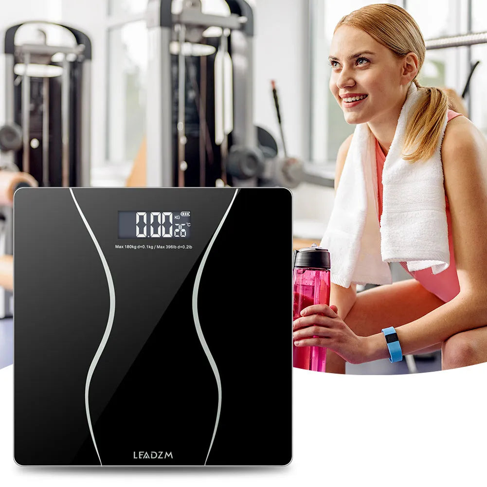 Black electronic household body scale with tempered glass platform and digital display