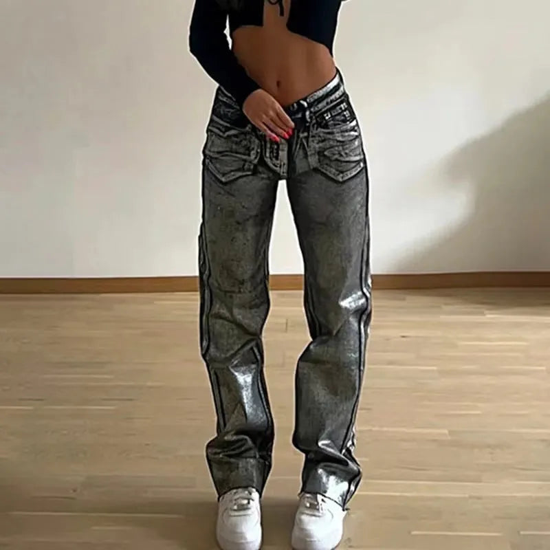 Blue high waist straight-leg denim jeans with contrast details on a neutral background.