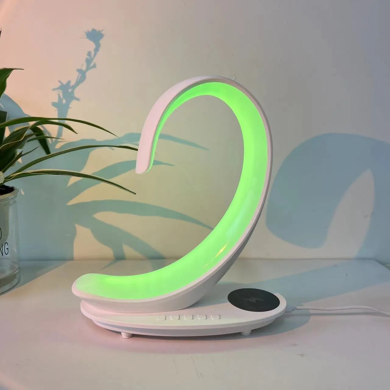 White swan shaped desktop wireless charger with Bluetooth speaker and colourful atmosphere lighting