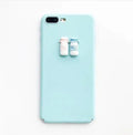 A soft pink silicone iPhone case featuring a raised 3D cartoon cat design on the back.