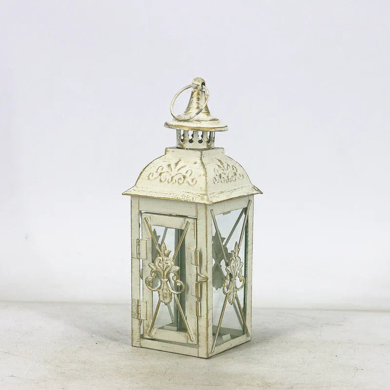 Black and white wrought iron floor-standing storm lantern with tempered glass in three sizes for courtyard use.