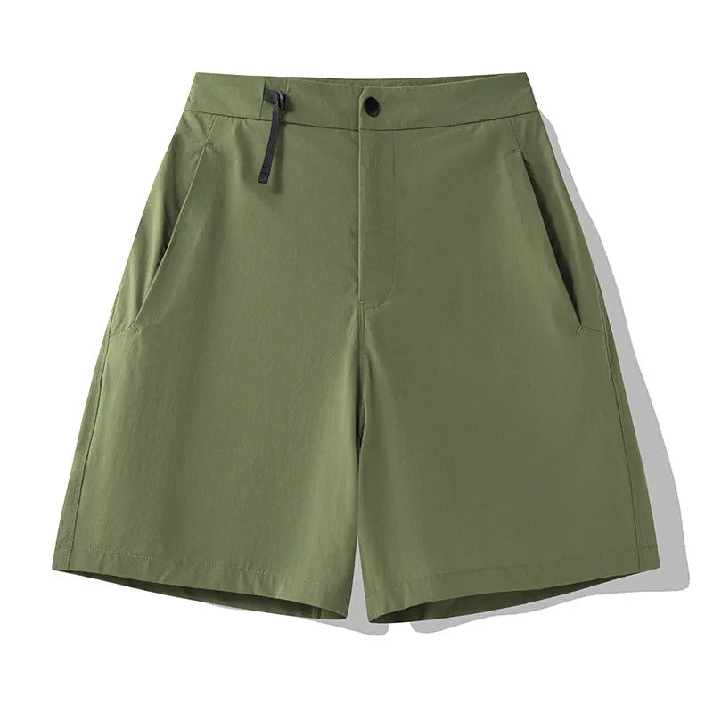 Men's solid colour quick-drying sports shorts with elastic waist on a neutral background.