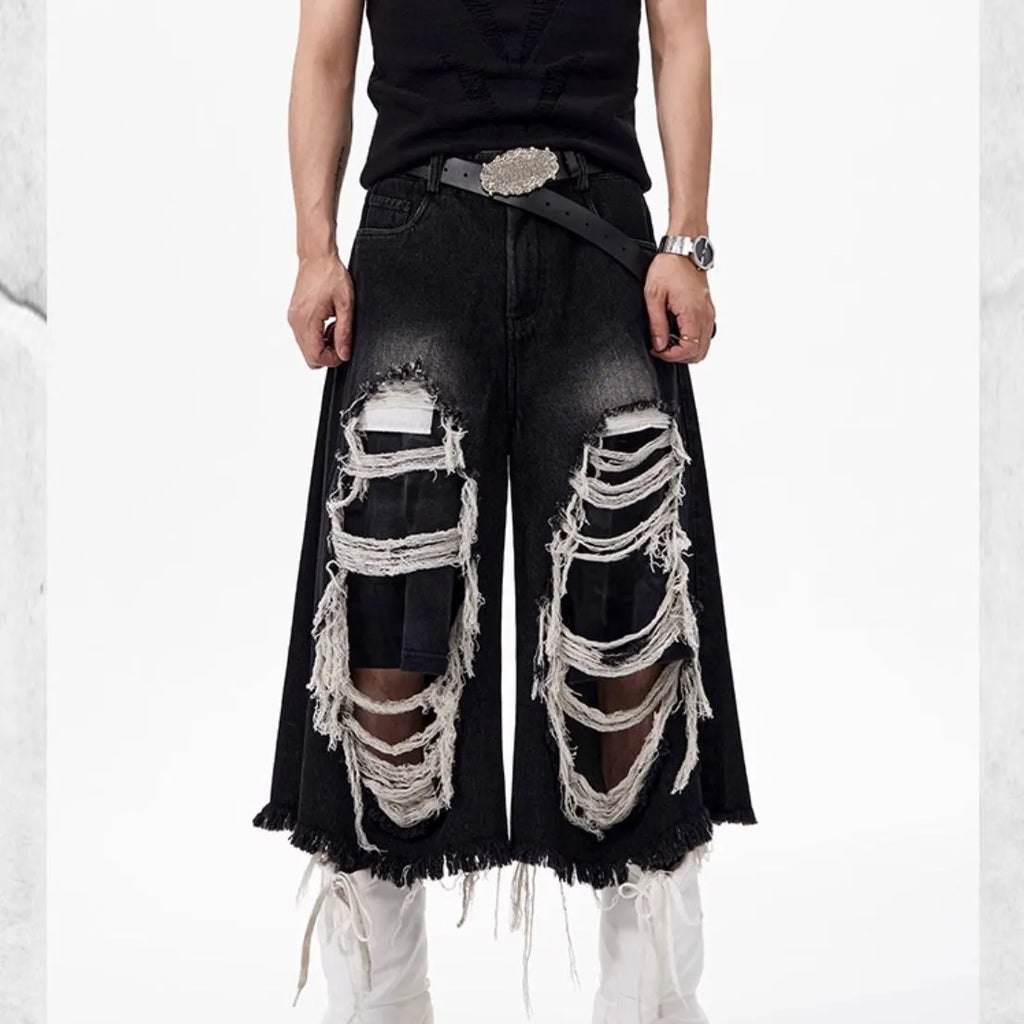 Black cropped wide leg jeans with mid-high waist and ripped patch detail on a loose fit.