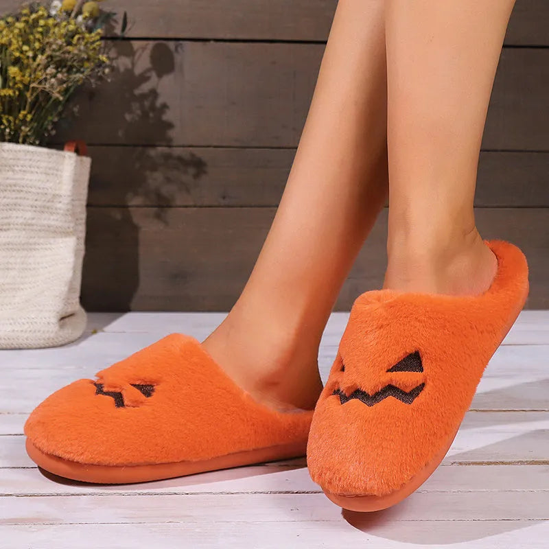 Orange Halloween pumpkin slippers with coral velvet upper and plush lining.