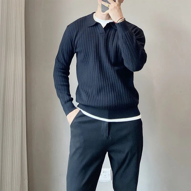 Man wearing a loose black textured knit pullover sweater with long sleeves.