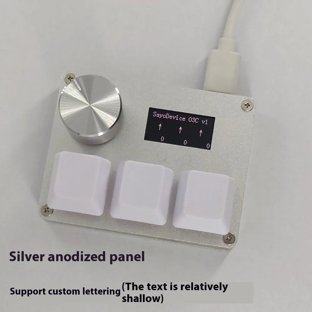 Customisable magnetic axis gaming keypad with programmable knob and colour IPS screen on desk.