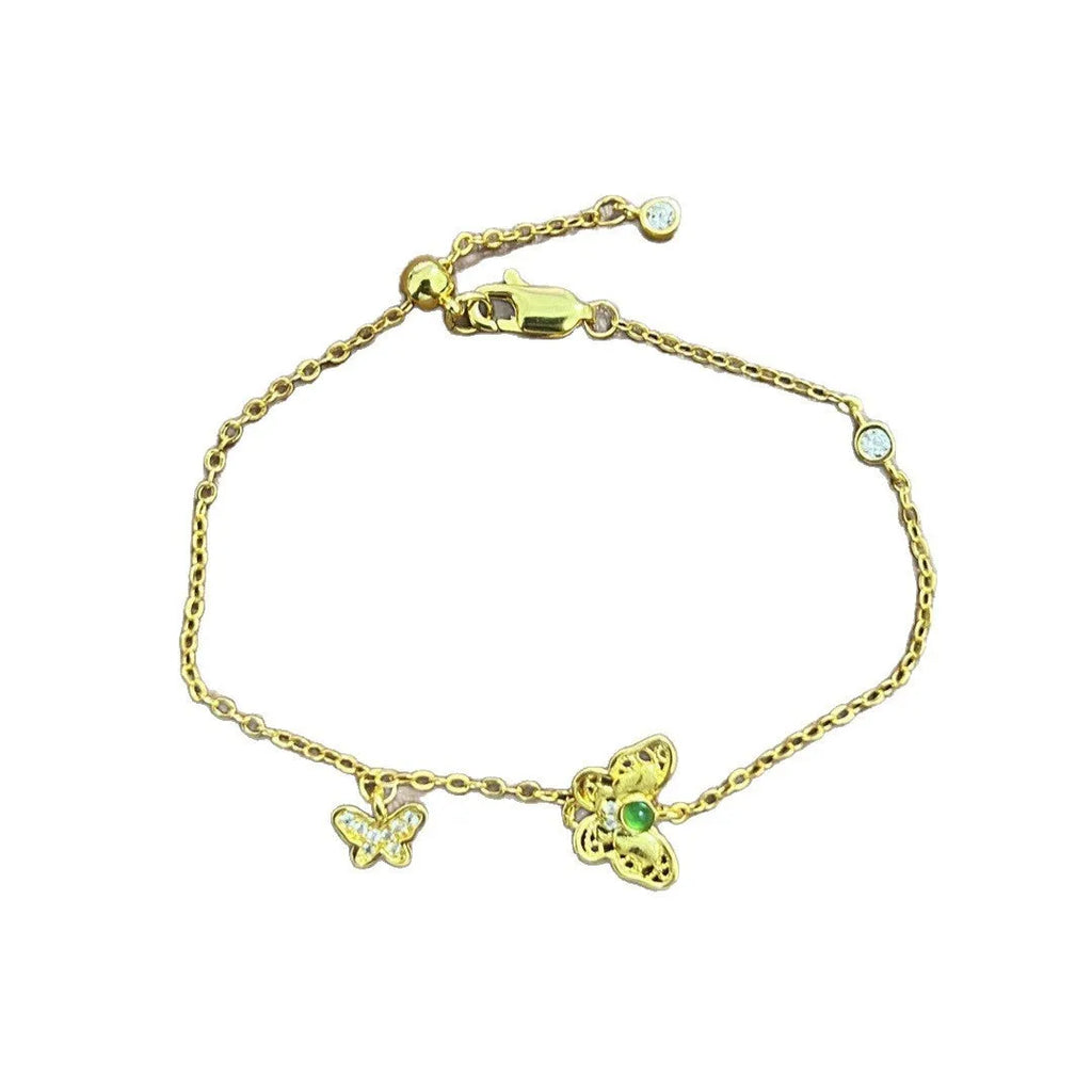 Gold copper hollow butterfly bracelet with wire drawing finish on display