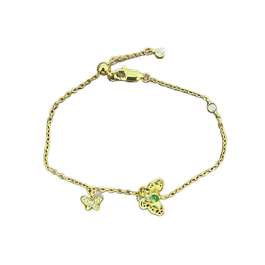 Gold copper hollow butterfly bracelet with wire drawing finish on display