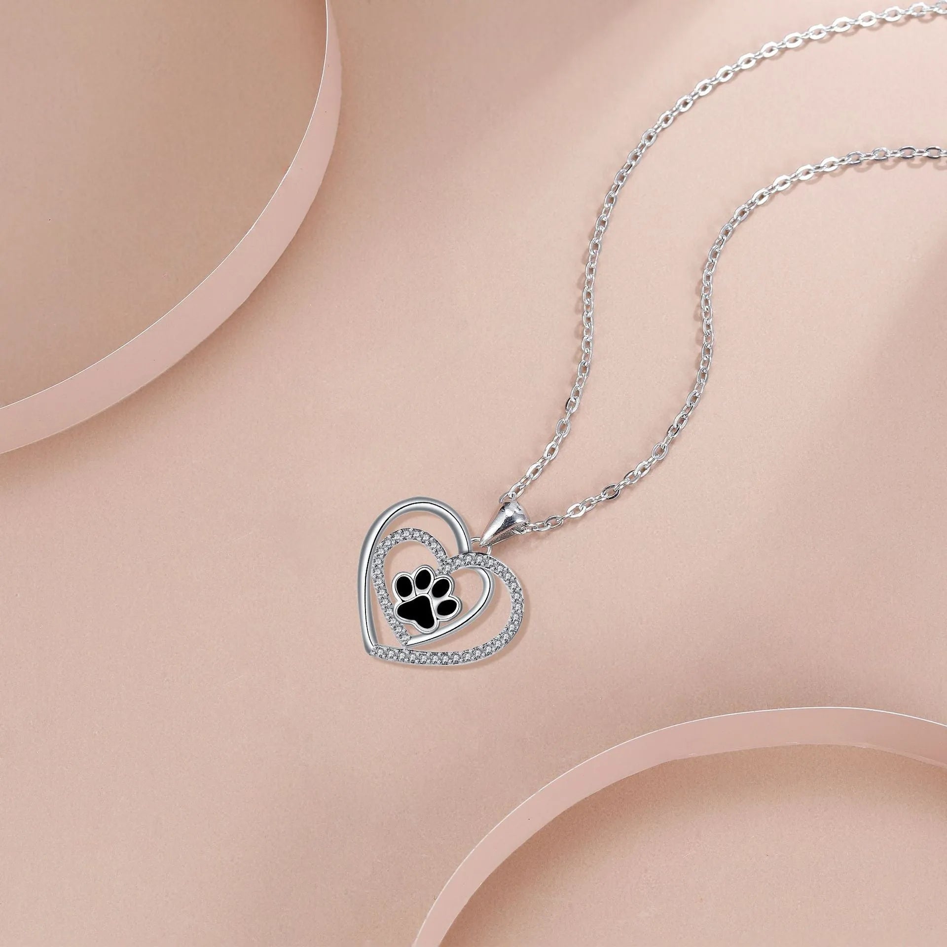 Women's necklace with dog paw print pendant on copper cross chain, heart-themed electroplated finish