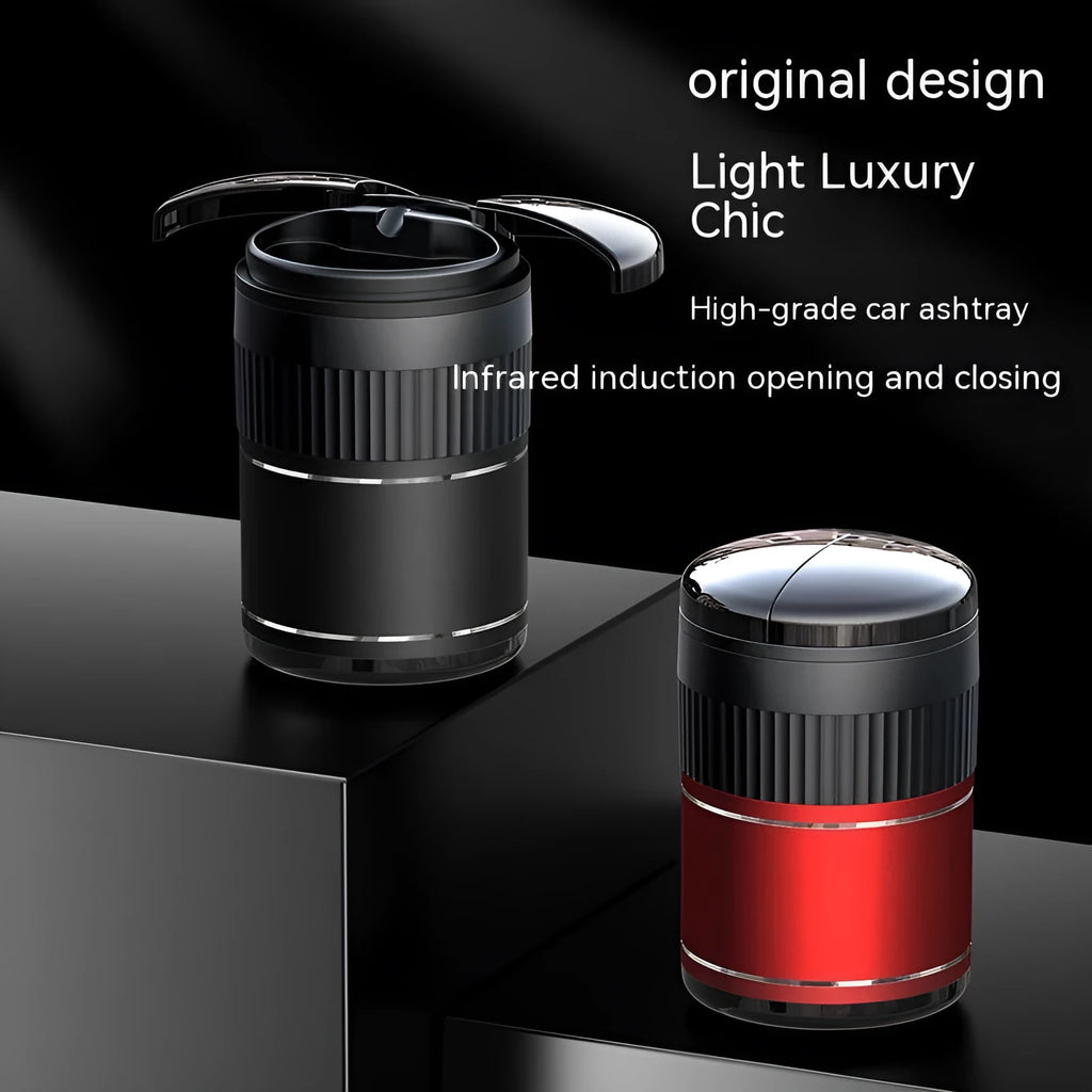Compact metal car ashtray with lid in black, showing automatic sensor or touch controls.