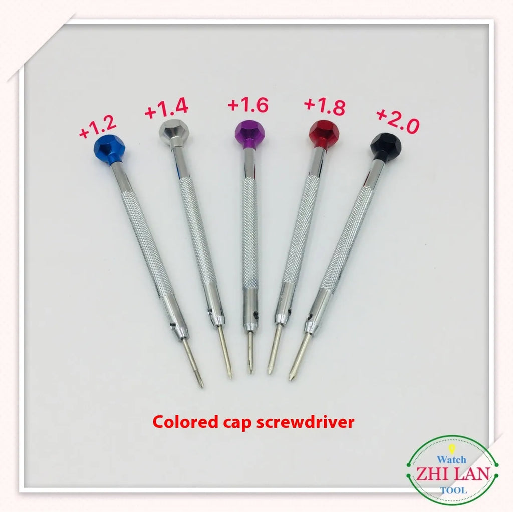 Six colour-coded watch repair screwdrivers with copper handles stored in an open aluminium case.