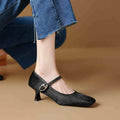 Women's black square toe stiletto ankle-strap shoes with horse hair upper and buckle fastening.
