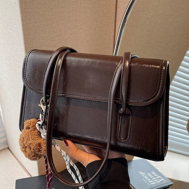 Women's brown PU leather shoulder bag with horizontal square shape and decorative pendant