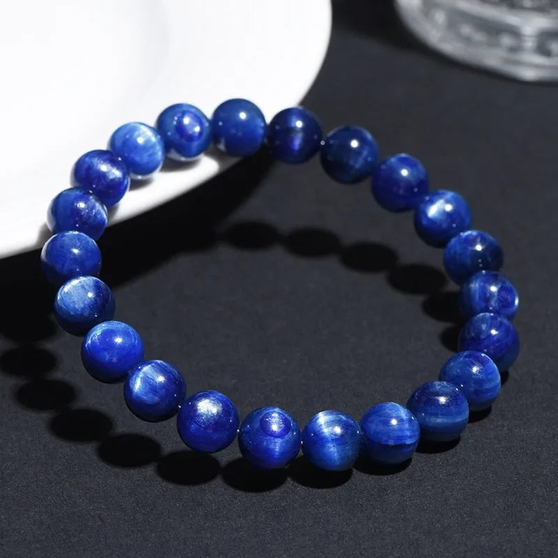 Geometric Ruyi design blue crystal ball bracelet with polished beads on a white background.