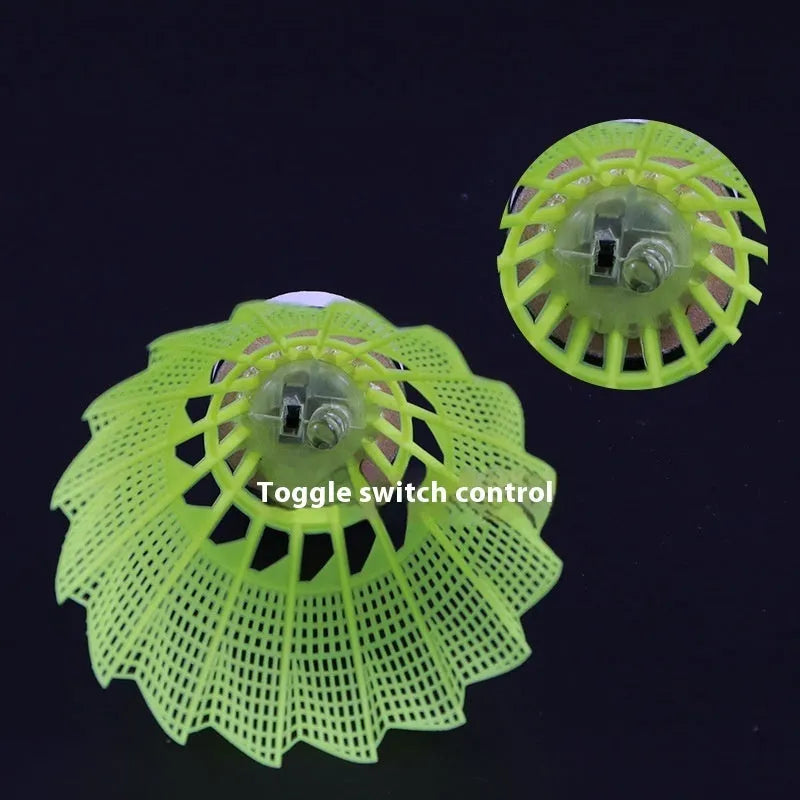 Luminous badminton shuttlecock with green glow, nylon construction, lying on court surface