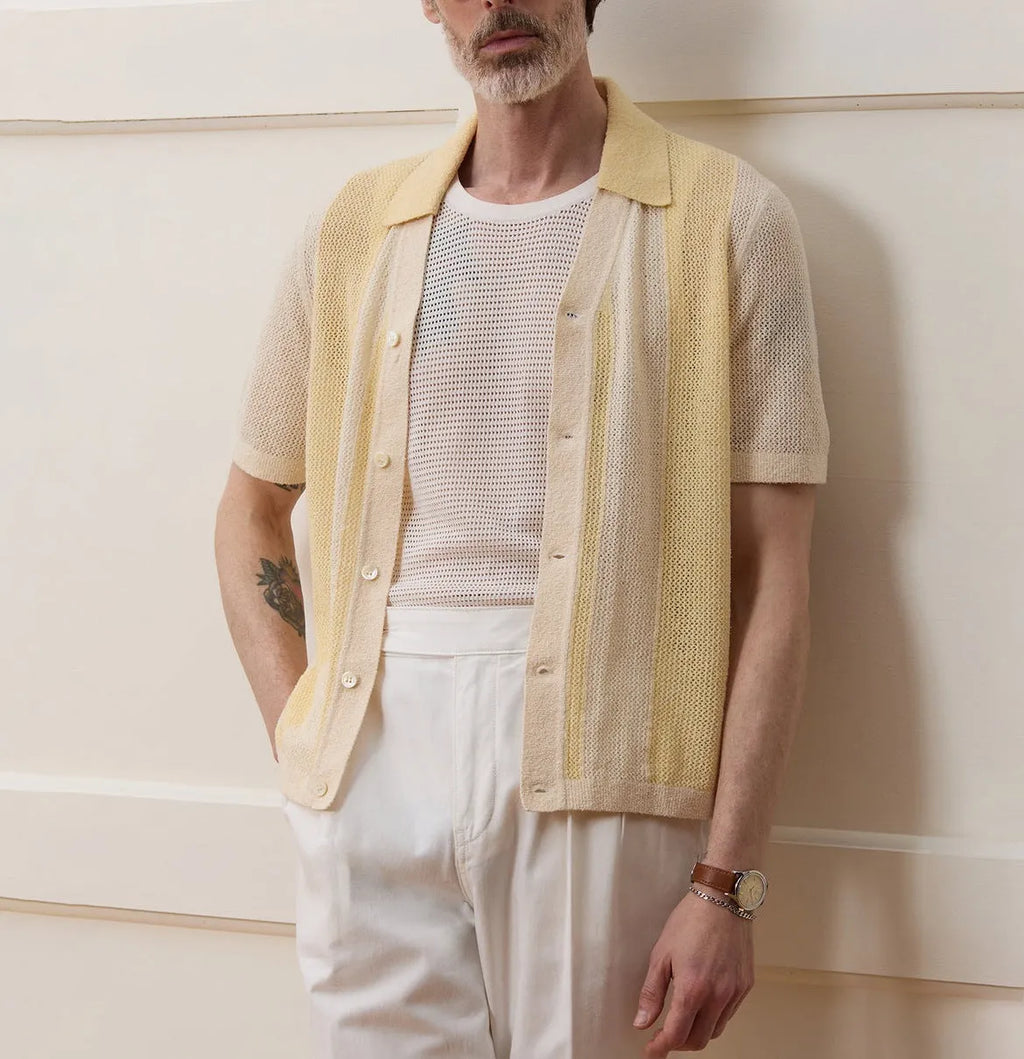 Yellow short-sleeved polo shirt with asymmetric design and hollow-out pattern details