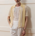 Yellow short-sleeved polo shirt with asymmetric design and hollow-out pattern details
