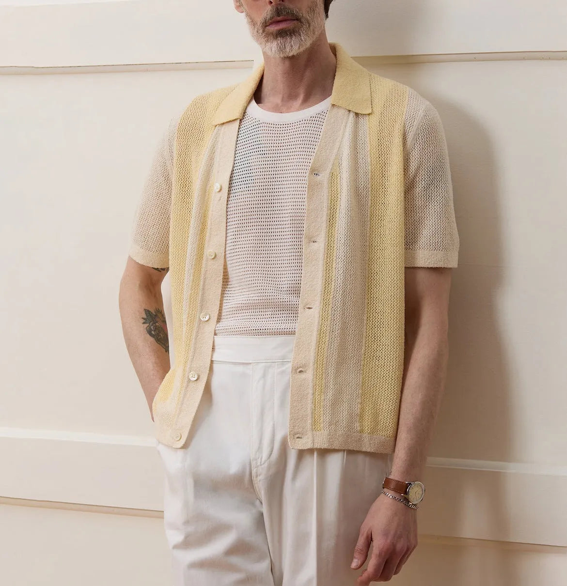 Yellow short-sleeved polo shirt with asymmetric design and hollow-out pattern details