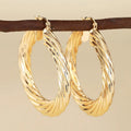Women's geometric ring design copper clip-on earrings in electroplated colours on a white background.
